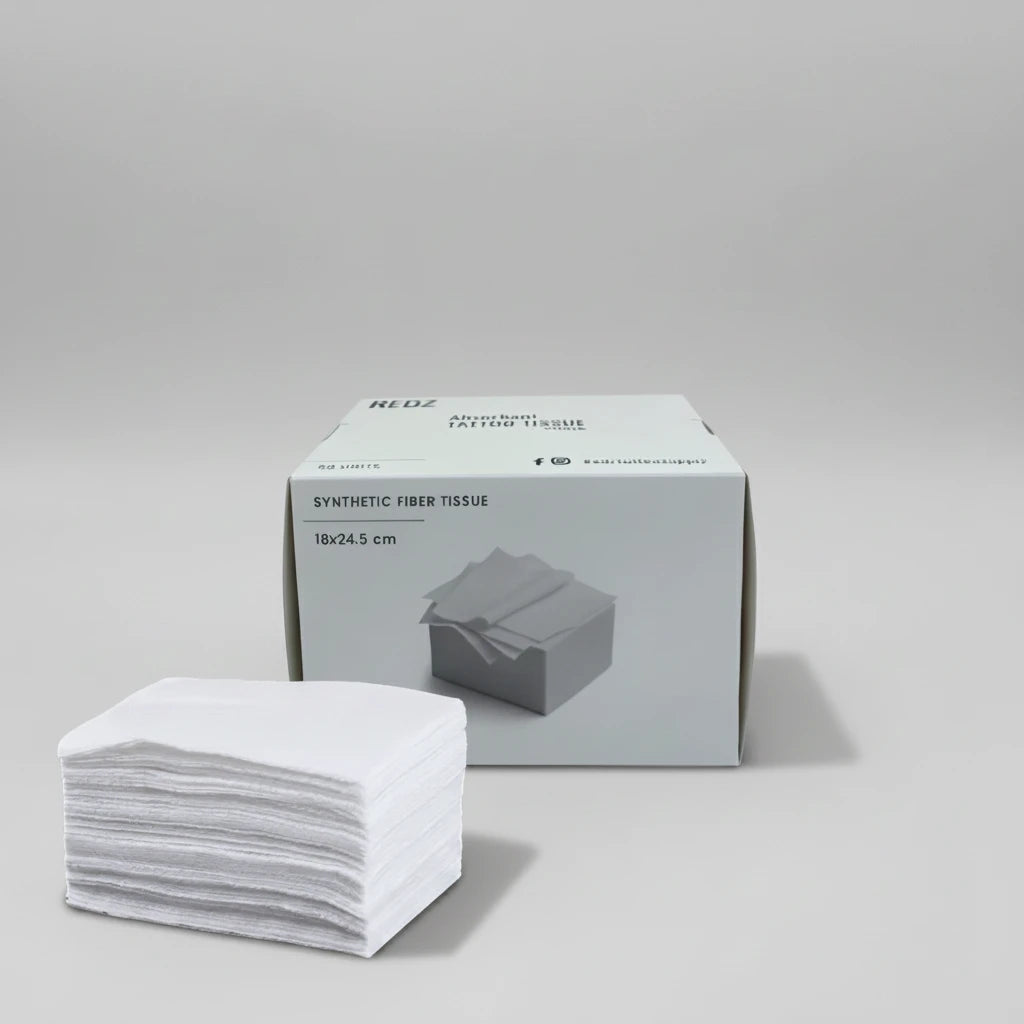 A stack of white synthetic fiber tissue pads placed in front of their light gray retail box on a plain white background.